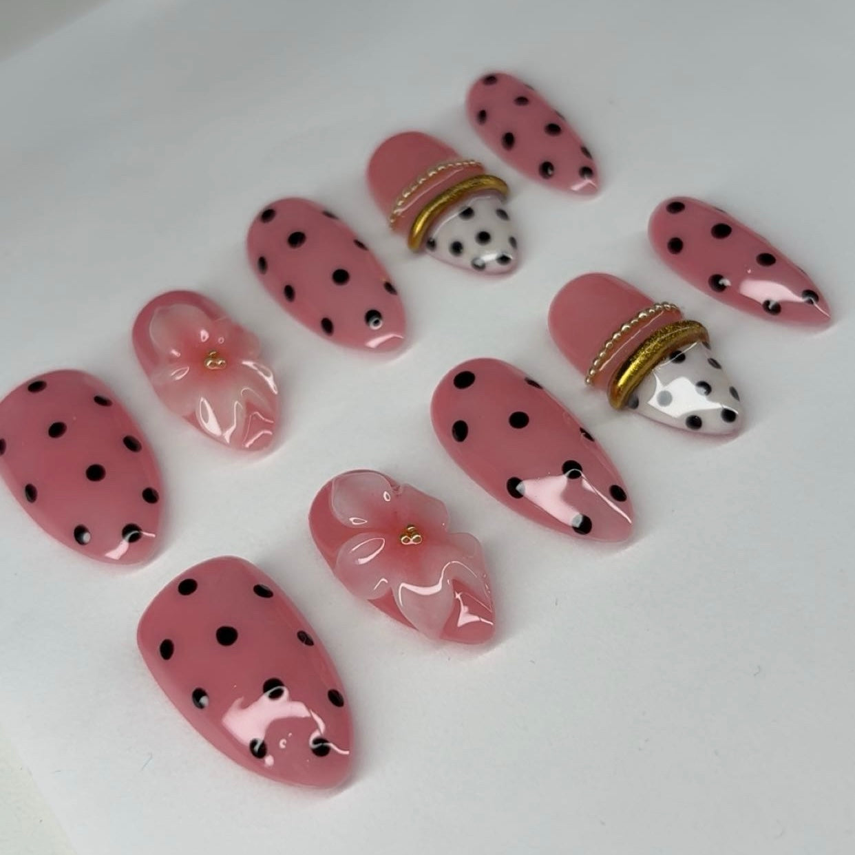 Press-on nails with 3d flowers, polka dot, and bangle french tip nail art