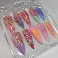 Zara Larsson inspired tropical summer press-on nails with 3d flower and aura nail art in clear storage case