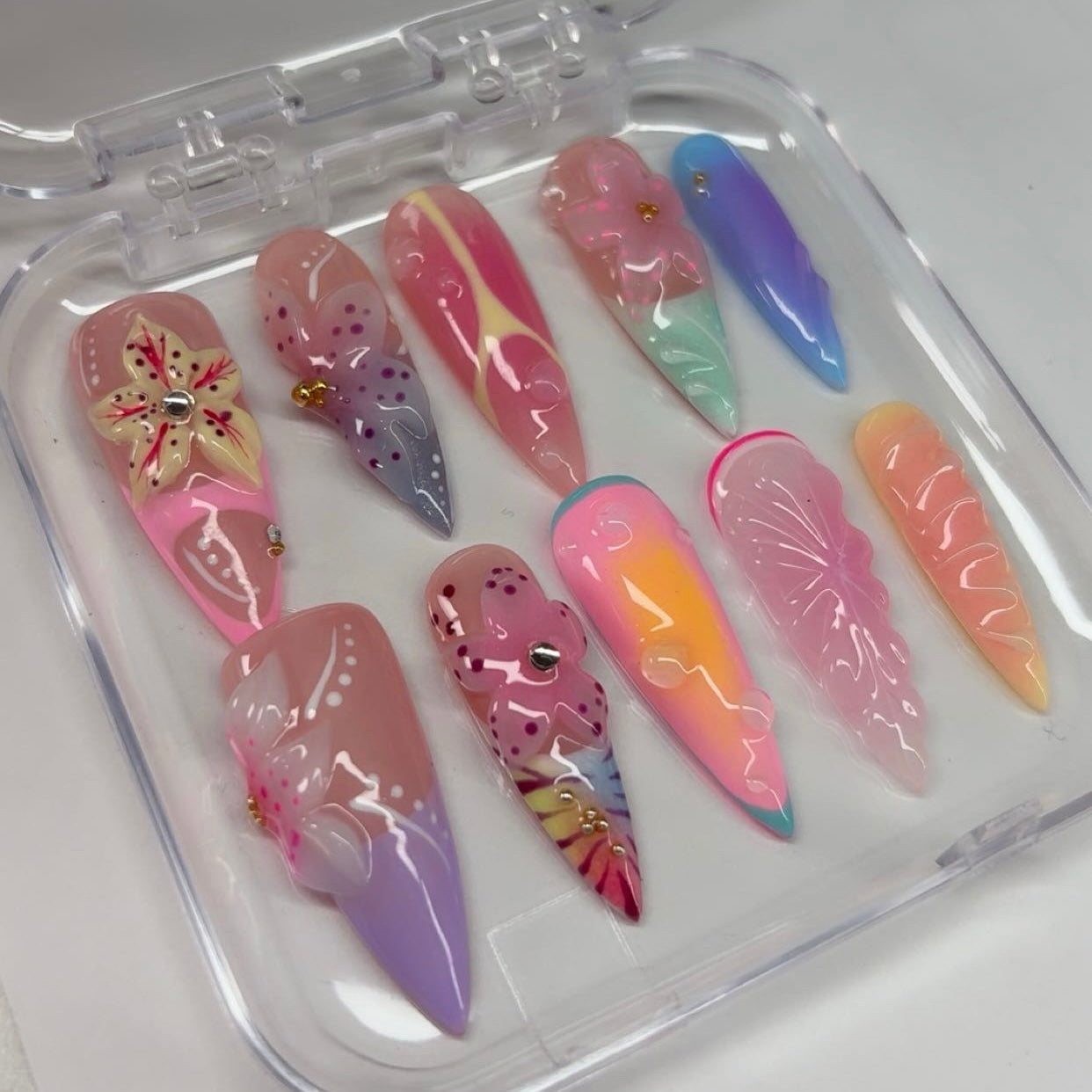 Zara Larsson inspired tropical summer press-on nails with 3d flower and aura nail art in clear storage case